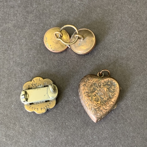 169 - A vintage rose metal heart locket together with rose and white metal buttons and a brooch (as found)