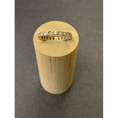 194 - A 9ct gold eternity ring set with white stones (does not test as diamonds), approx. size N, weight a... 