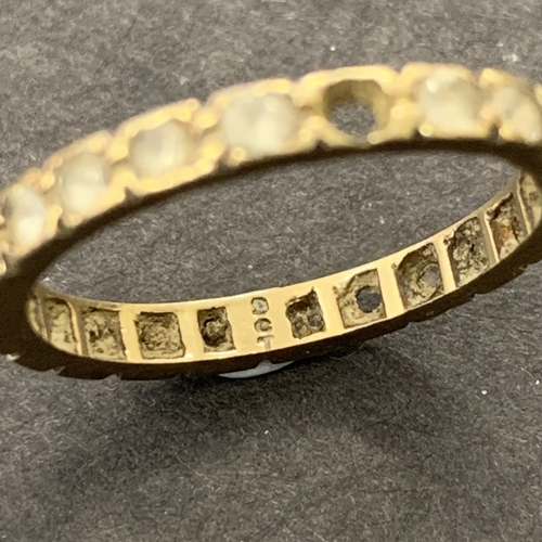 194 - A 9ct gold eternity ring set with white stones (does not test as diamonds), approx. size N, weight a... 