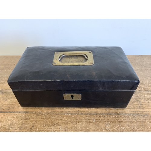 250 - An antique leather covered jewellery box with lift out tray, brass handle with engraved back plate '... 