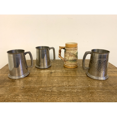 260 - Three vintage pewter tankards plus a Japanese German style tankard