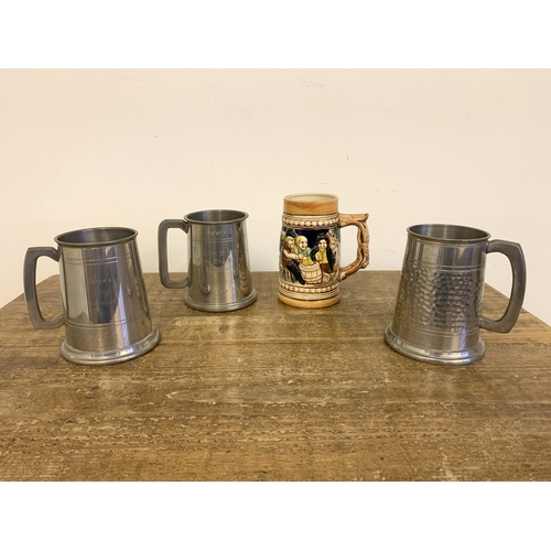 260 - Three vintage pewter tankards plus a Japanese German style tankard