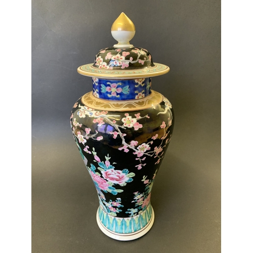 265 - A vintage Oriental covered vase with enamel decoration of flowers, character mark to base, approx. 1... 