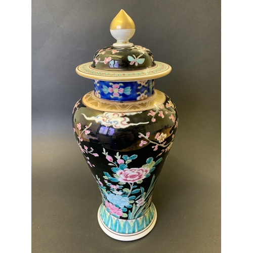 265 - A vintage Oriental covered vase with enamel decoration of flowers, character mark to base, approx. 1... 