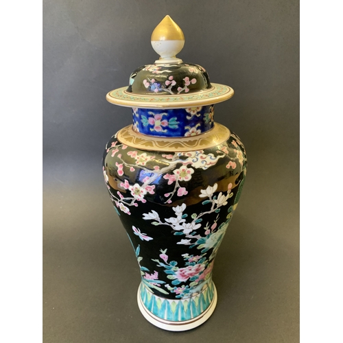 265 - A vintage Oriental covered vase with enamel decoration of flowers, character mark to base, approx. 1... 