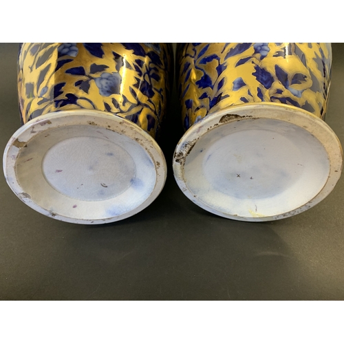 266 - A pair of vintage covered vases decorated in cobalt blue and gilding, no marks to base, approx. 15 3... 