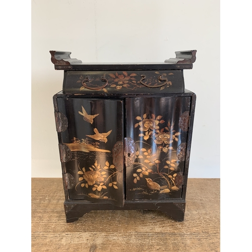 275 - A vintage Oriental small cabinet of drawers decorated with red lacquer and over gilding with scenes ... 