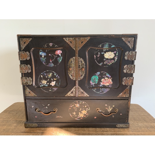 276 - A vintage Oriental cabinet of drawers over decorated in panels of flowers with gilding, six internal... 