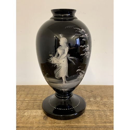 277 - A large Mary Gregory style vase, white enamel decoration on a black glass body, approx. 10 1/2