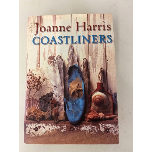 297 - Various mixed books including dragon subjects, a signed Joanne Harris 'Coast Liners' U.S.A. edition,... 