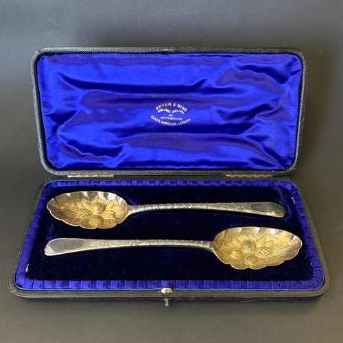 299 - A fine cased pair of Georgian hallmarked silver spoons with later Victorian berry decoration, one ha... 