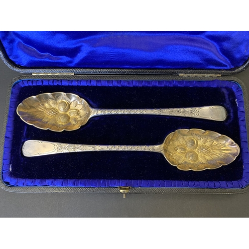 299 - A fine cased pair of Georgian hallmarked silver spoons with later Victorian berry decoration, one ha... 