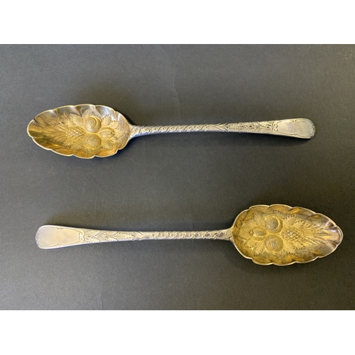 299 - A fine cased pair of Georgian hallmarked silver spoons with later Victorian berry decoration, one ha... 