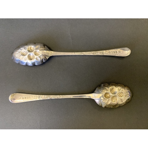 299 - A fine cased pair of Georgian hallmarked silver spoons with later Victorian berry decoration, one ha... 