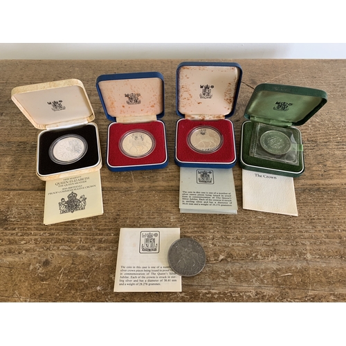 310 - Four cased commemorative crowns with one loose