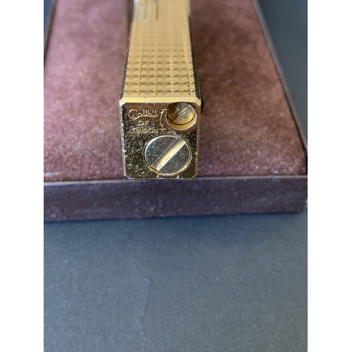 326 - A boxed vintage Colibri London gold finish lighter (signs of use)