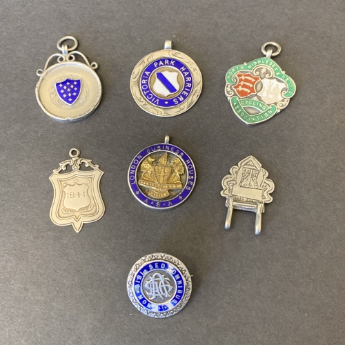 334 - Six hallmarked silver and enamel fobs including sporting subjects plus a 925 sterling part buckle, t... 