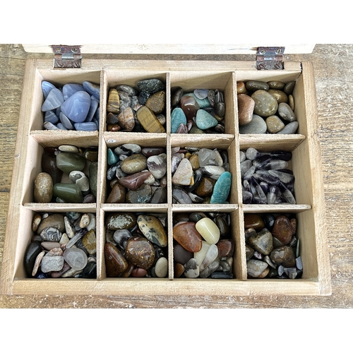 140 - A wooden box containing various polished gem stones and agates