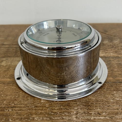 18 - A white metal bulkhead barometer, marked 'Howlett Smith Gt Yarmouth', 5 3/4