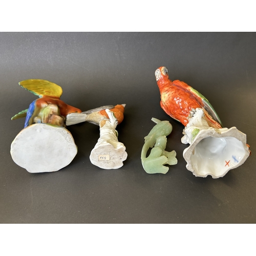 189 - Two 19th Century German porcelain parrot figures, a similar figure of a finch plus one other bird or... 