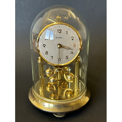 226 - A vintage 'Bentima' anniversary clock under glass dome, approx. 7