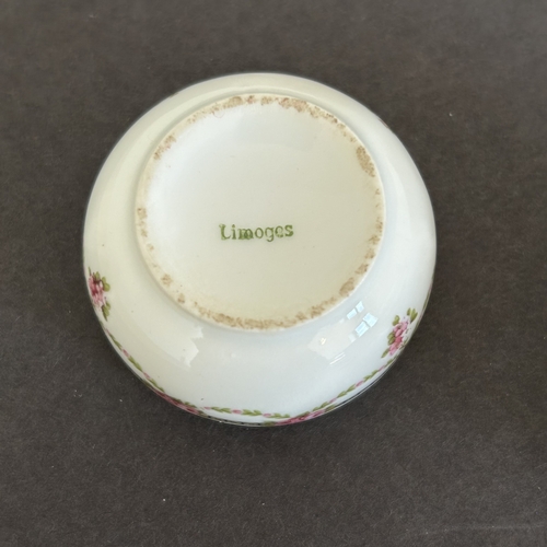 227 - A boxed Limoges porcelain pair of salts with white metal rims and spoons (one rim loose and one hing... 