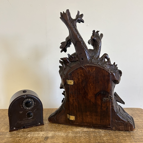 228 - A vintage carved Black Forest style chiming table clock with deer and tree decoration, the movement ... 