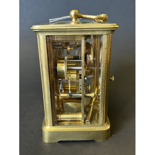 234 - A vintage brass cased chiming carriage clock with key, approx. 5 3/4