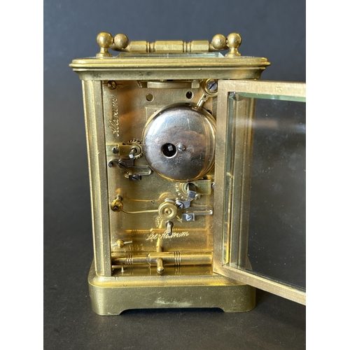 234 - A vintage brass cased chiming carriage clock with key, approx. 5 3/4