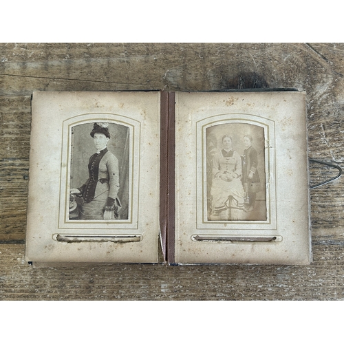 242 - An antique small photograph album, nearly full of photos with leather covered outer (old repair to s... 