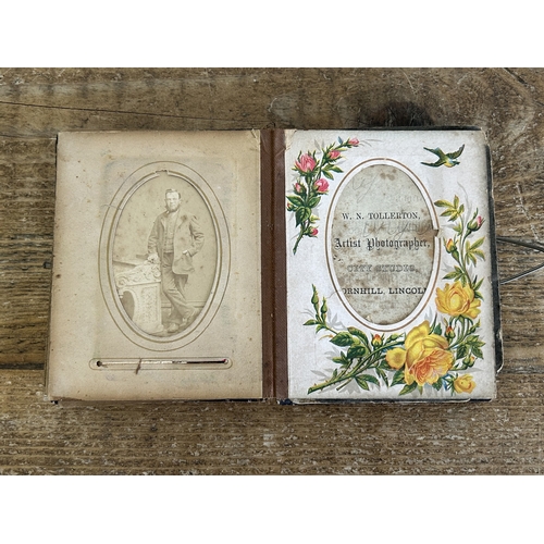 242 - An antique small photograph album, nearly full of photos with leather covered outer (old repair to s... 