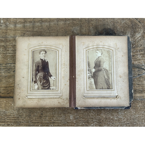 242 - An antique small photograph album, nearly full of photos with leather covered outer (old repair to s... 