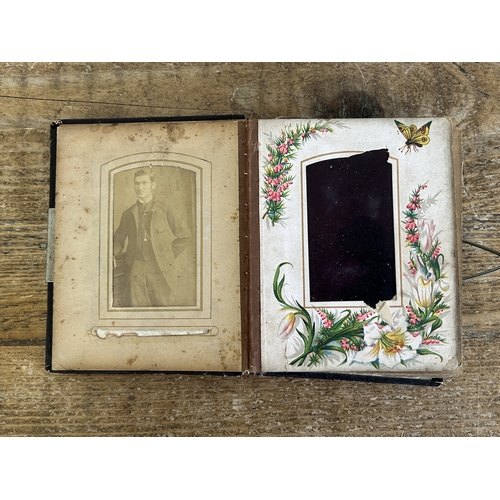 242 - An antique small photograph album, nearly full of photos with leather covered outer (old repair to s... 