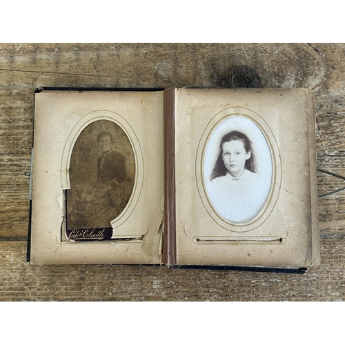 242 - An antique small photograph album, nearly full of photos with leather covered outer (old repair to s... 