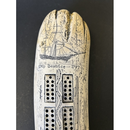 243 - A boxed resin copy of a marine scrimshaw tusk in the form of a crib board, based on the 1797 design ... 