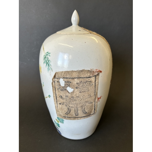 252 - An antique Chinese hand painted lidded vase, it still has a paper seal in place and contains somethi... 