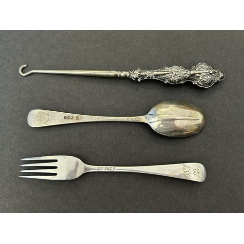 282 - A Sheffield hallmarked silver childs spoon and fork plus a silver handled button hook