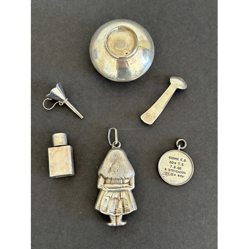 287 - A hallmarked silver childs rattle in the form of a girl, a perfume funnel, cycling fob and a small p... 