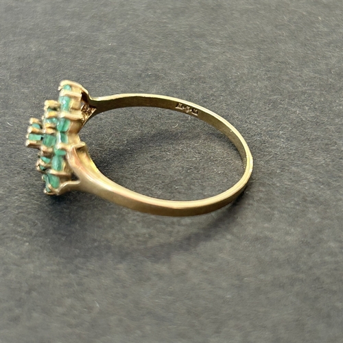 291 - A 9ct gold and emerald daisy cluster ring, approx. size Q, weight approx. 1.9g