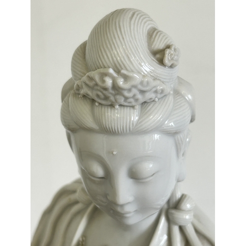 30 - An Oriental Blanc-de-Chine style figurine, 17