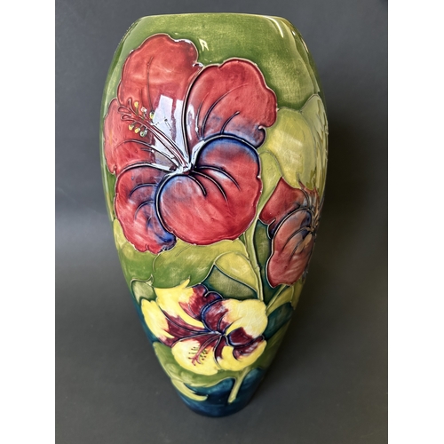 52 - A vintage Moorcroft vase in the 'Hibiscus' pattern, with pink By Appointment to the Late Queen Mary ... 