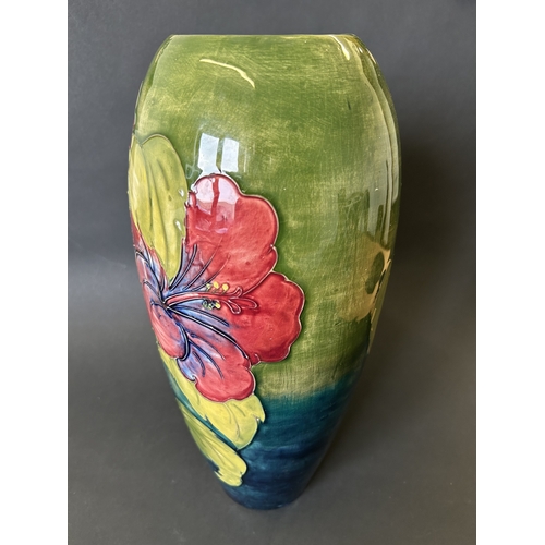 52 - A vintage Moorcroft vase in the 'Hibiscus' pattern, with pink By Appointment to the Late Queen Mary ... 