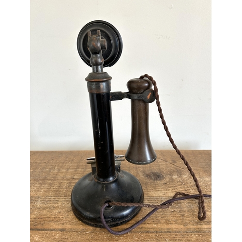 66 - An early 20th Century Bakelite candlestick telephone, stands 12