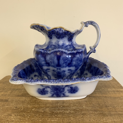 7 - An antique Alcock & Son flow blue large sized jug and bowl, the jug is 11 1/2