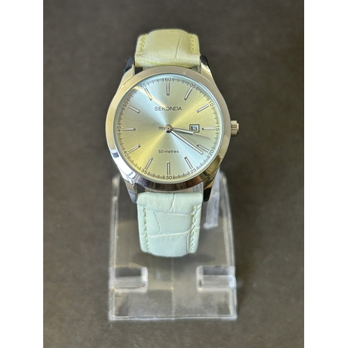 104 - A ladies Sekonda wristwatch on leather strap, 30mm dia (leather strap with wear, runs and ticks)