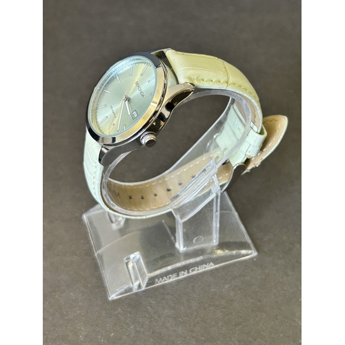 104 - A ladies Sekonda wristwatch on leather strap, 30mm dia (leather strap with wear, runs and ticks)