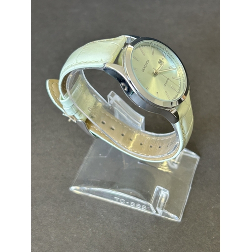 104 - A ladies Sekonda wristwatch on leather strap, 30mm dia (leather strap with wear, runs and ticks)