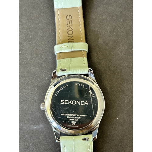 104 - A ladies Sekonda wristwatch on leather strap, 30mm dia (leather strap with wear, runs and ticks)
