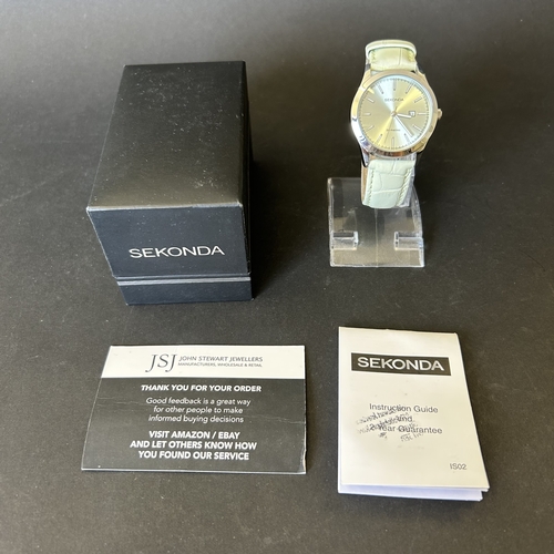 104 - A ladies Sekonda wristwatch on leather strap, 30mm dia (leather strap with wear, runs and ticks)