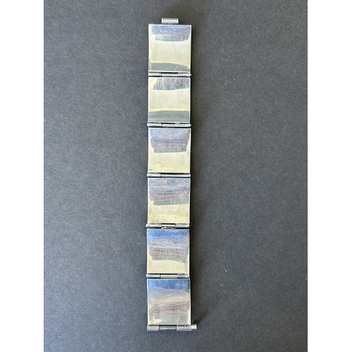127 - An Egyptian white metal bracelet, is does bear stamp marks on three of the sections, weight approx. ... 